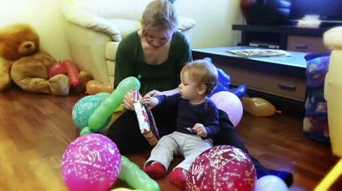 Baby boy opening present Stock Footage 8849413