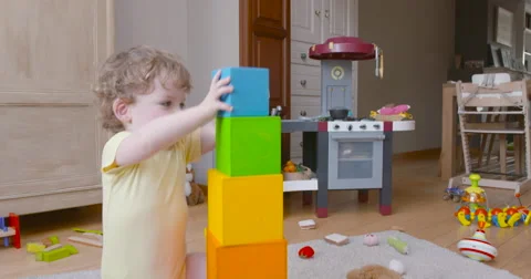 Baby boy pilling square blocks slow motion 60fps Stock Footage 57652351