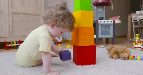 Baby boy pilling two square blocks slow motion 60fps Stock Footage 57652841