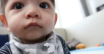 Baby boy playful attack a camera with curiosity Stock Footage 85993699