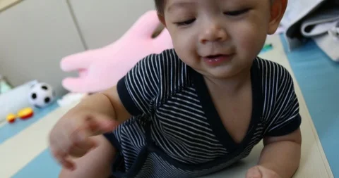 Baby boy playful attack a camera Stock Footage 86771402