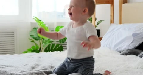 Baby boy playing on bed Stock Footage 156519320