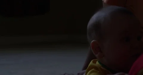 Baby boy plays with toy on ground Stock Footage