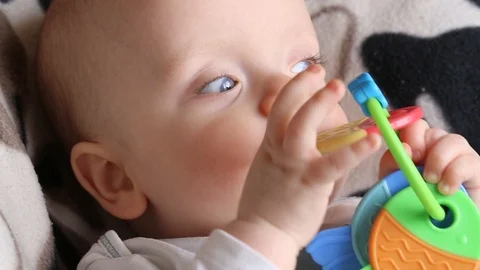 Baby boy with a rattle Stock Footage 103532140