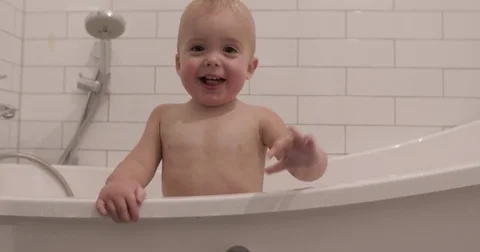 Baby boy smiling and looking at camera bathroom Stock Footage 80811069