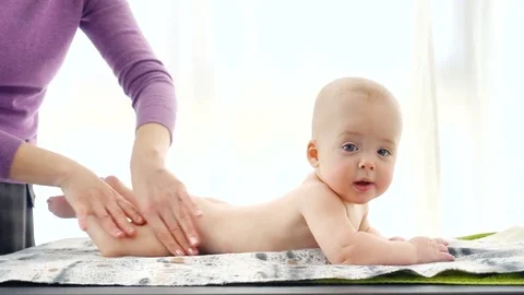 Baby boy smiling while enjoying massage Video stock 72061293