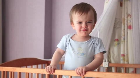 Baby Boy Standing in Cot Stock Footage 61878630