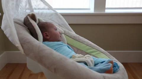 A baby boy in a swing Stock Footage 45734283