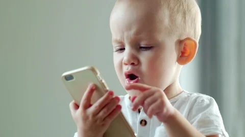 Baby Boy Tapping on Smartphone Stock Footage 101041567