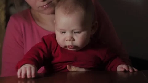Baby Boy Tapping Table Sitting on Mother's Lap Stock Footage 71896113