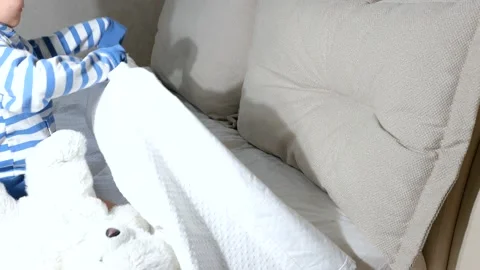 Baby boy with teddy bear getting ready go sleep in bed Stock Footage 151928592