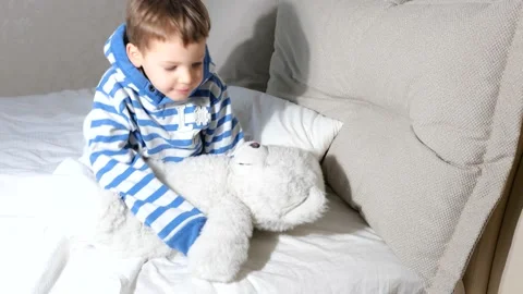 Baby boy with teddy bear getting ready go sleep in bed Stock Footage 151928694