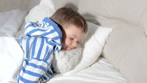 Baby boy with teddy bear getting ready go sleep in bed Stock Footage 151928913