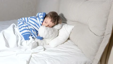 Baby boy with teddy bear getting ready go sleep in bed Stock Footage 151929087