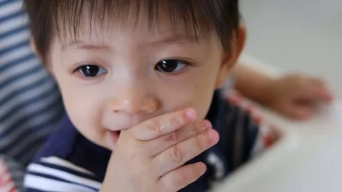 Baby boy using finger hand in mouth itchy gum Stock Footage 82331075