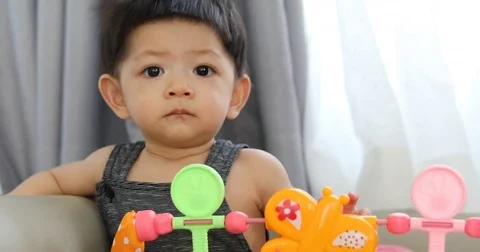 Baby boy using finger hand playing colorful toy Stock Footage 82371209