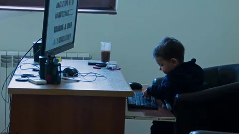 Baby Boy on Workdesk Using Keyboard Stock Footage 71380738