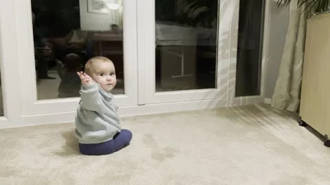 Baby bum shuffling, looking at reflection, waving goodbye. Stock Footage 260318065