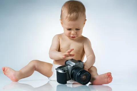 Baby with camera Stock Photos