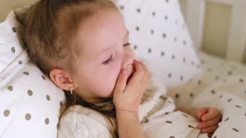Baby cannot fall asleep lying in bed due to severe coughing attacks. Stock Footage 165132149