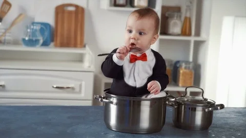 Baby chef sitting in a pot Stock Footage 73097000