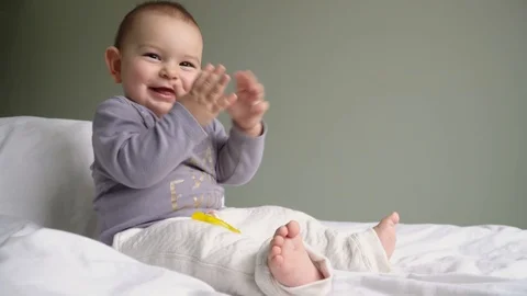 baby clapping hands sitting sofa Stock Video Pond5