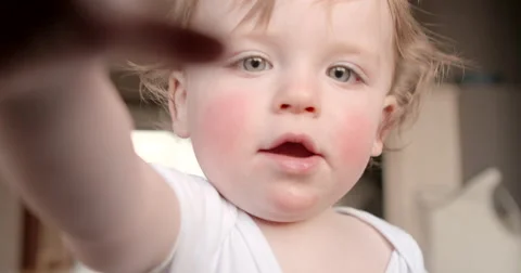 Baby close up grabbing for camera Stock Footage 50144898