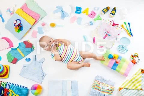 Baby with clothing and infant care items Stock Photos