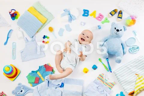 Baby with clothing and infant care items Stock Photos