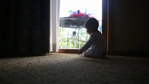 Baby crawling by window, video Stock Footage 77816860