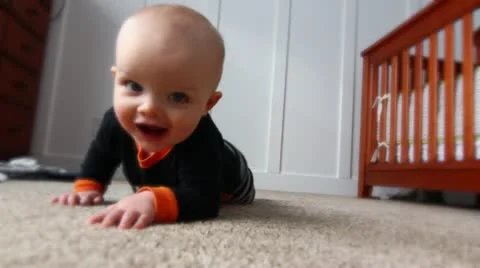 Baby crawls across the floor Stock Footage