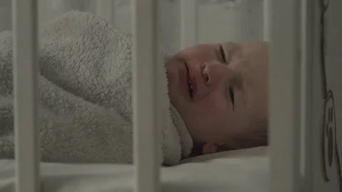 Baby cries because he does not want to sleep. Video stock 73743098