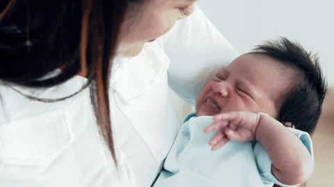 Baby crying because of hungry  Mom feeding Stock Footage 276844129
