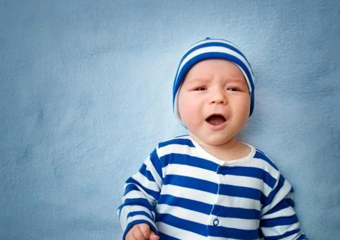 Baby crying in bed Stock Photos