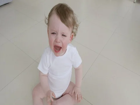 Baby crying sitting on the floor Stock Footage 72253066