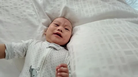 Baby Crying on Soft Bed Stock Footage 313834900