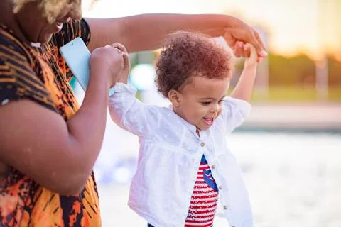 Baby daughter's first steps Stock Photos