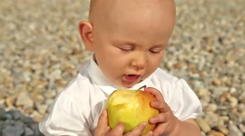 Baby doesn't like apple - close up Stock Footage 21243371