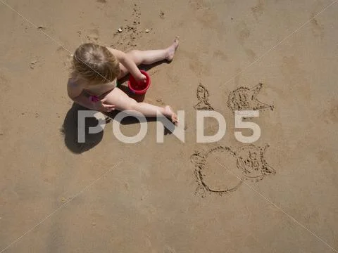 Baby drawing on sand Stock Photos