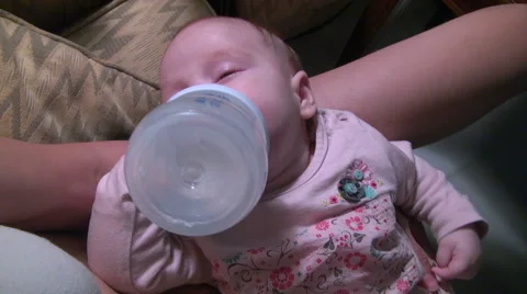 Baby drinking herself bottle Stock Footage 44119909