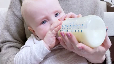 Baby drinking milk from bottle. Stock Footage 174765683