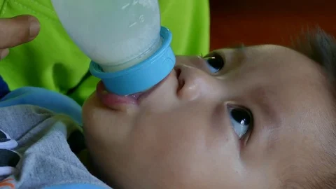 Baby is drinking milk Stock Footage 82971419