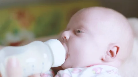 Baby drinks from a bottle Stock Footage 112693302