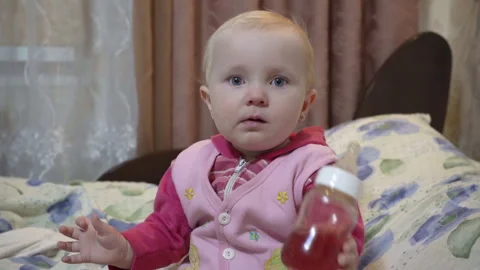 Baby drinks from a bottle Stock Footage 257298405