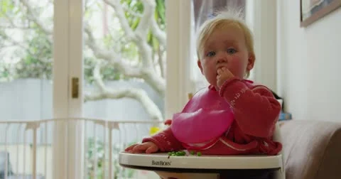 Baby eating dinner Stock Footage 12549396