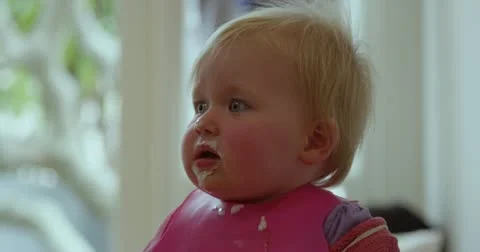 Baby eating dinner Stock Footage 12575478