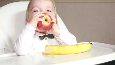 Baby eats an Apple Stock Footage 138650460