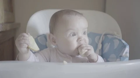The baby eats an apple laughing, happy, delicious Stock Footage 115348601