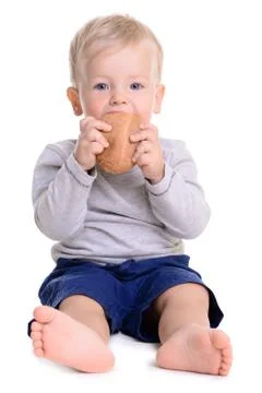 Baby eats bread Stock Photos