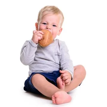 Baby eats bread Stock Photos